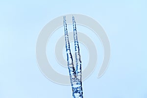 Spear from the ice on the background of the sky