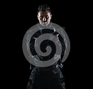 Spec ops police officer SWAT in black uniform studio