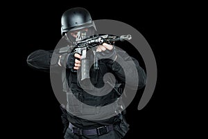 Spec ops police officer SWAT in black uniform studio