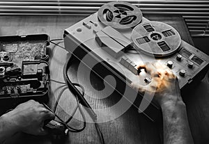 Special agent holds field telephone set USSR. Officer wiretapping   on the reel tape recorder. KGB spying conversations