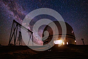 Special astrophysical observatory against starry night sky with milky way photo