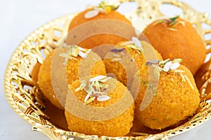 Special Banarasi Laddu Indian Mithai Made Of Bengal Gram Flour Deep Fried In Desi Ghee In Golden Tray. Meetha Laddoo Served On