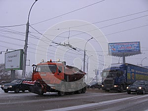 Special cars clean the street from snow cleaning road equipment in the city in winter