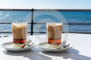 Special coffee of Canary islands, sweet barraquito coffee with layers and alcohol served in glass photo