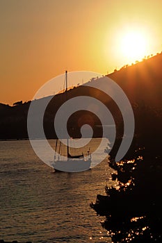 Sunset with sailing boat photo