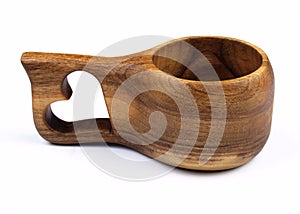 Special cup made of wood with heart . Household kitchen utensils of walnut wood for drink