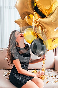 Special day amused laughing brunette girl balloons