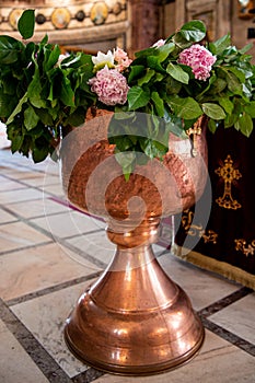 Special Decor for Baptism. The baptismal font and the priest table. Baptism ceremony