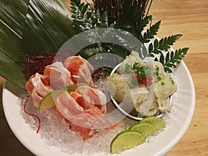 Special Deluxe Combination sashimi set Salmon, Engawa and seaweed on ice sever with wasabi and lime, Japanese food