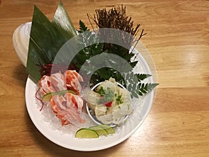 Special Deluxe Combination sashimi set Salmon, Engawa and seaweed on ice sever with wasabi and lime, traditional Japanese food on