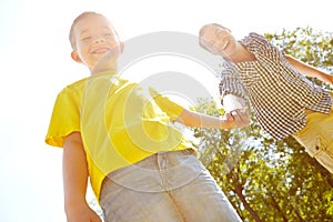 Special father-son moments. Young father and his son spending time outdoors while smiling widely.