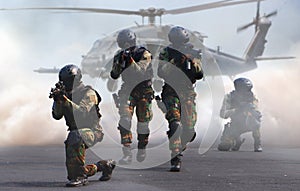 Special force assault team in a mission with helicopter photo