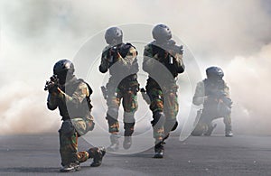 Special force assault team under smoke screen background