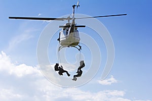 Special forces in helicopter with sky on background