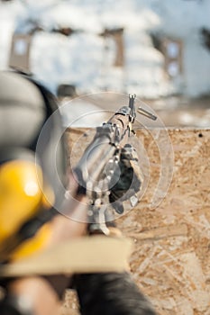 Special forces soldier in action, shooting from rifle machine gun