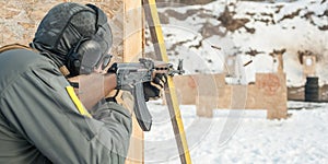 Special forces soldier in action, shooting from rifle machine gun