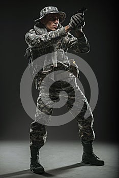 Special forces soldier man with gun on a dark background