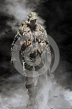 Special forces soldier man hold Machine gun on a dark background