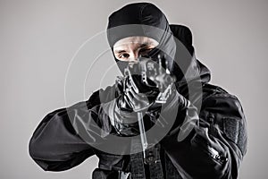 Special forces soldier man hold Machine gun on a grey background