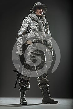 Special forces soldier man with Machine gun on a dark background