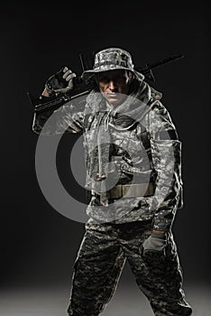 Special forces soldier man with Machine gun on a dark background