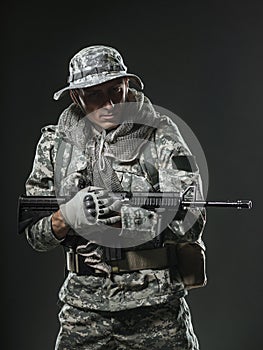 Special forces soldier man with Machine gun on a dark background