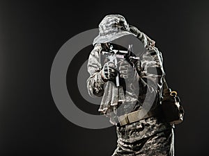 Special forces soldier man with Machine gun on a dark background