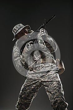 Special forces soldier man with Machine gun on a dark background