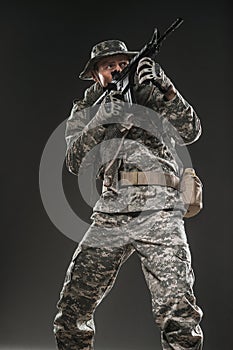 Special forces soldier man with Machine gun on a dark background