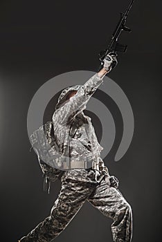 Special forces soldier man with Machine gun on a dark background