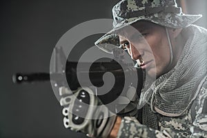 Special forces soldier man with Machine gun on a dark background