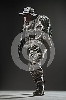 Special forces soldier man with Machine gun on a dark background