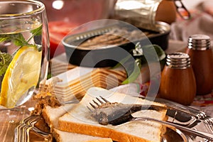 Fork for sprat with fish on a piece of bread