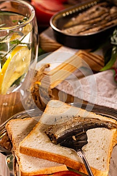 Fork for sprat with fish on a piece of bread
