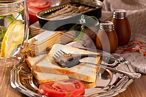 Fork for sprat with fish on a piece of bread