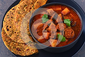 Methi Thepla and Gujarati ringan nu shaak, brinjal curry photo
