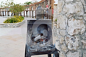 Special iron black metal oven, brazier for the preparation of hot, uncoiled coals for a traditional hookah in Egypt