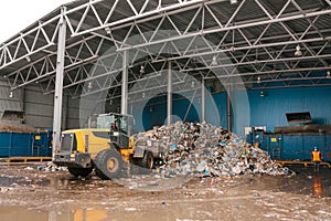 Special machinery or bulldozer work on the site of waste unloading at the plant for waste disposal.