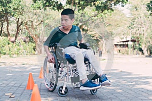 Special need child practicing wheelchair by parents