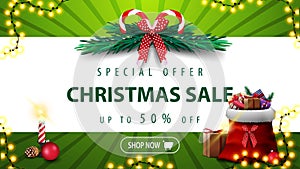 Special offer, Christmas sale, up to 50% off, green banner with horizontal white stripe, Christmas tree wreath, candle.