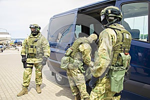 Special-purpose team arrived at the exercises. They unload weapons and special equipment from a minibus. The concept of defense,