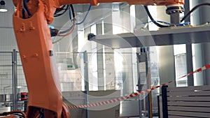 Special robotic arm uses suction cups to drag big panels at a factory.