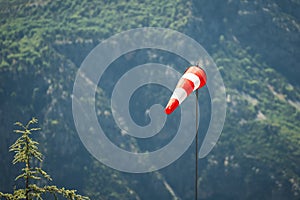 special sock with red and white stripes for measuring wind strength and direction is installed on airfields and runways