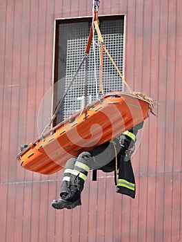 special stretcher for the rescue of the injured is lowered with