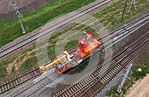 Special train with a landing crane for service and repair of electrical networks on the railway. Workers doing service work on