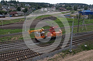 Special train with a landing crane for service and repair of electrical networks on the railway. Workers doing service work on