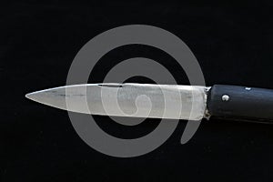 A special turkish knife. testing the sharpness of the blade on the black floor. a small pocket knife, a small shepherd`s knife,