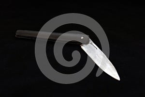 A special turkish knife. testing the sharpness of the blade on the black floor. a small pocket knife, a small shepherd`s knife,