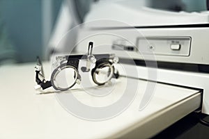 specialised ophthalmologist's spectacles to check vision during an optometric examination of person