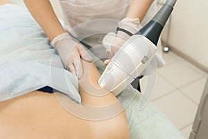 The specialist deals with hair removal from the client`s hand.